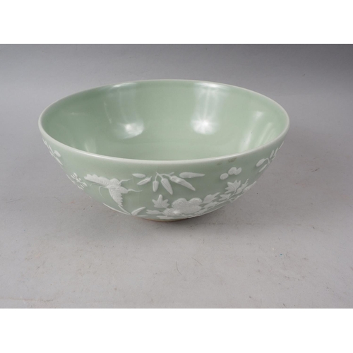 100 - A Chinese porcelain celadon glazed bowl, decorated in high relief with flowers and butterflies, 10 1... 