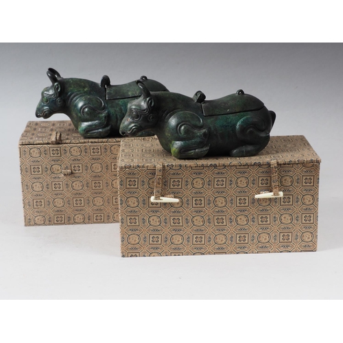 102 - A pair of Chinese bronze limited edition lamps, formed as recumbent cows, 26/50 and 35/50, 7 1/4