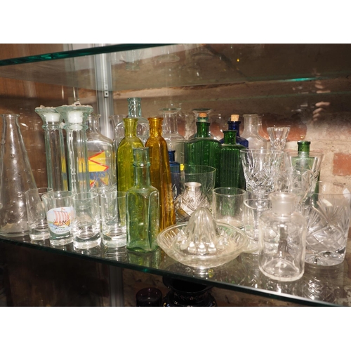 52 - An assortment of glassware, including a pair of candlesticks, drinking glasses, poison bottles and o... 