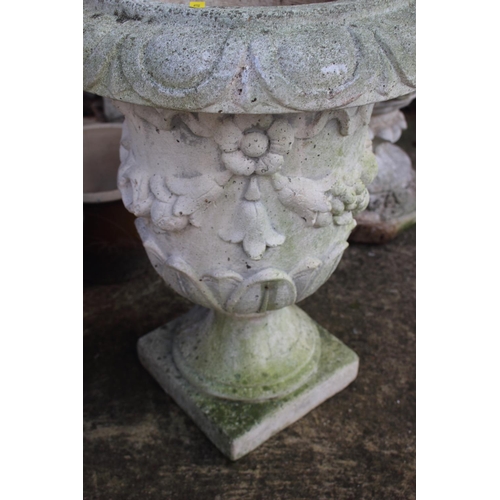 551 - A cast stone urn with swag decoration, 22