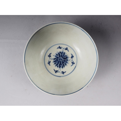 70 - A Chinese blue and white bowl with lotus flower and scrolled decoration, six character mark to base,... 