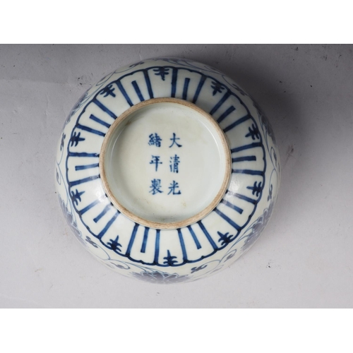 70 - A Chinese blue and white bowl with lotus flower and scrolled decoration, six character mark to base,... 