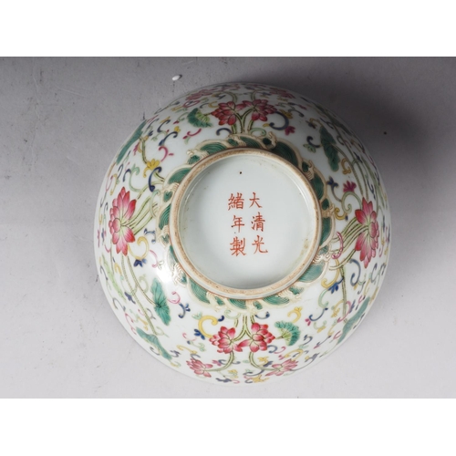 73 - A Chinese famille rose bowl with floral and scrolled polychrome decoration and six character mark to... 