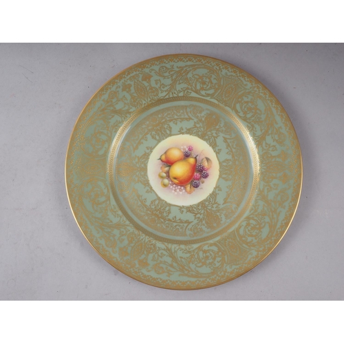 9 - A pair of Royal Worcester cabinet plates with celadon glazed and gilt borders and central fruit deco... 