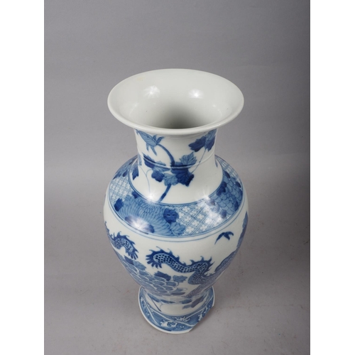 95 - A 19th century Chinese blue and white baluster vase, decorated two dragons and flowers, 15 high (los... 