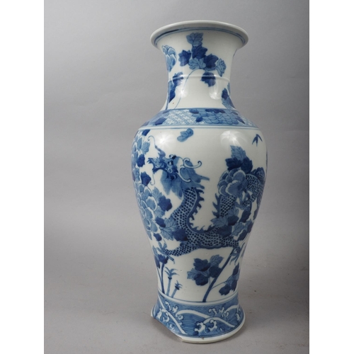 95 - A 19th century Chinese blue and white baluster vase, decorated two dragons and flowers, 15 high (los... 