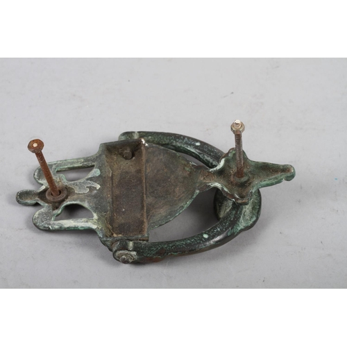 24 - A brass door knocker of Neoclassical design