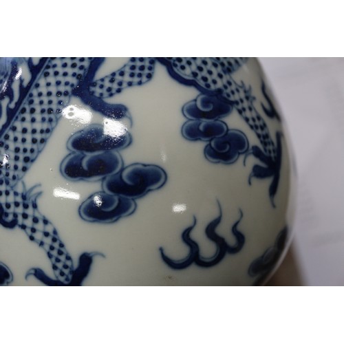 79 - A Chinese blue and white sprinkler bottle vase, decorated dragon, phoenix, clouds and scrolls, with ... 