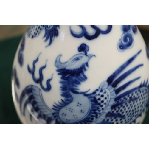 79 - A Chinese blue and white sprinkler bottle vase, decorated dragon, phoenix, clouds and scrolls, with ... 