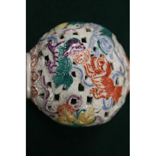 86 - A Chinese porcelain pierced and relief decorated snuff bottle, no stopper, seal mark to base, 2 5/8