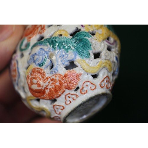 86 - A Chinese porcelain pierced and relief decorated snuff bottle, no stopper, seal mark to base, 2 5/8