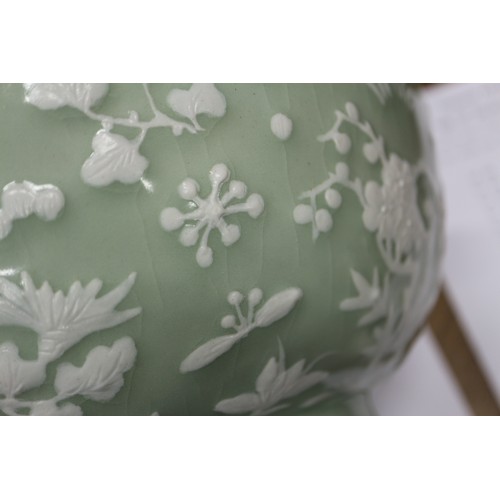 100 - A Chinese porcelain celadon glazed bowl, decorated in high relief with flowers and butterflies, 10 1... 