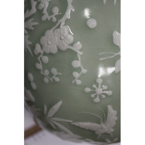 100 - A Chinese porcelain celadon glazed bowl, decorated in high relief with flowers and butterflies, 10 1... 