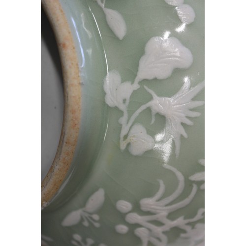 100 - A Chinese porcelain celadon glazed bowl, decorated in high relief with flowers and butterflies, 10 1... 