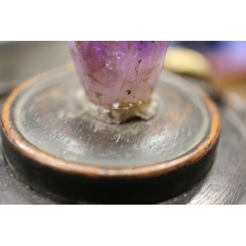 107 - A Chinese brass censor with engraved decorated and carved wooden top and amethyst knop, on three tap... 