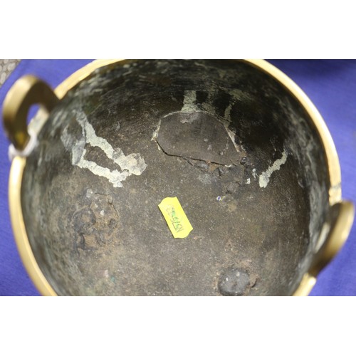 107 - A Chinese brass censor with engraved decorated and carved wooden top and amethyst knop, on three tap... 