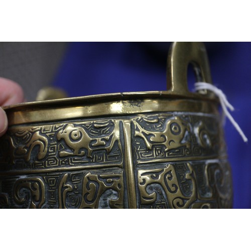 107 - A Chinese brass censor with engraved decorated and carved wooden top and amethyst knop, on three tap... 