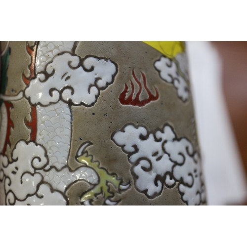 96 - A Chinese cylindrical brush pot, decorated dragon amongst clouds with flaming pearl 4 1/8