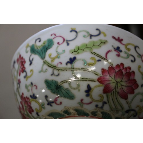 73 - A Chinese famille rose bowl with floral and scrolled polychrome decoration and six character mark to... 