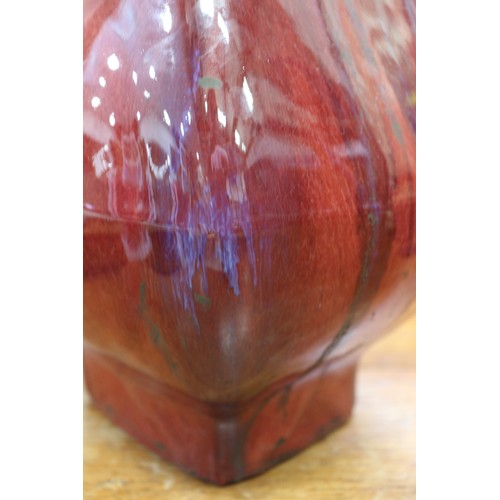 80 - A sang de beouf glazed bulbous vase with handles, 11 3/4