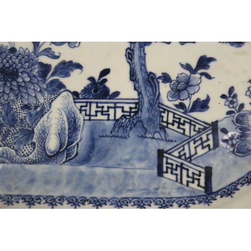 75 - A Chinese blue and white platter, decorated birds, a tree and a fence, 16 1/2