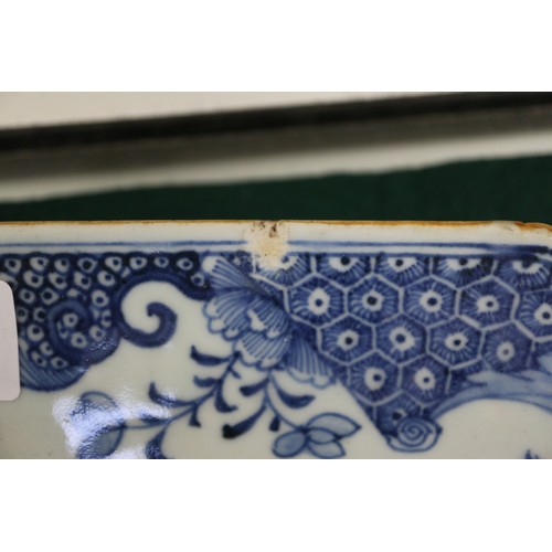 75 - A Chinese blue and white platter, decorated birds, a tree and a fence, 16 1/2