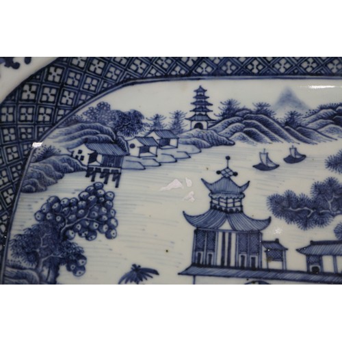 75 - A Chinese blue and white platter, decorated birds, a tree and a fence, 16 1/2