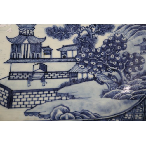 75 - A Chinese blue and white platter, decorated birds, a tree and a fence, 16 1/2