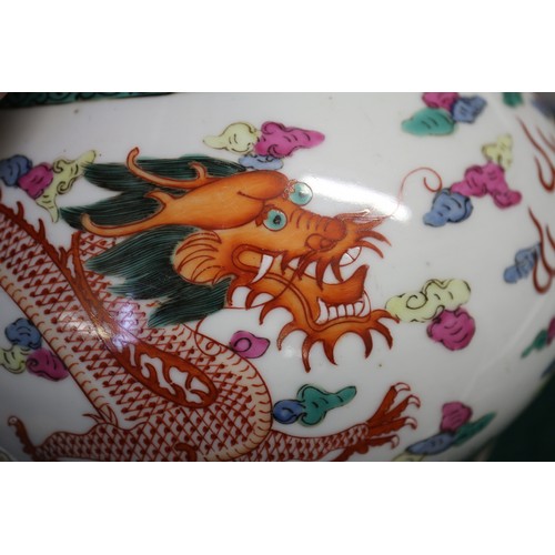 76 - A Chinese famille verte bulbous vase with polychrome dragon and cloud decoration, four character mar... 