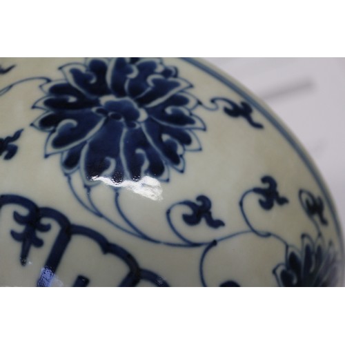 70 - A Chinese blue and white bowl with lotus flower and scrolled decoration, six character mark to base,... 