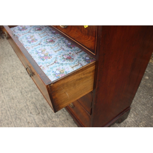 436 - A 19th century figured mahogany chest of two short and three long graduated drawers with oval brass ... 