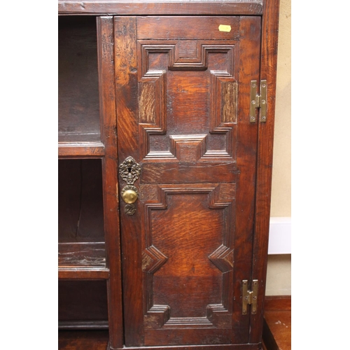 437 - A 19th century oak dresser, the upper section fitted open shelves and cupboards enclosed panelled do... 