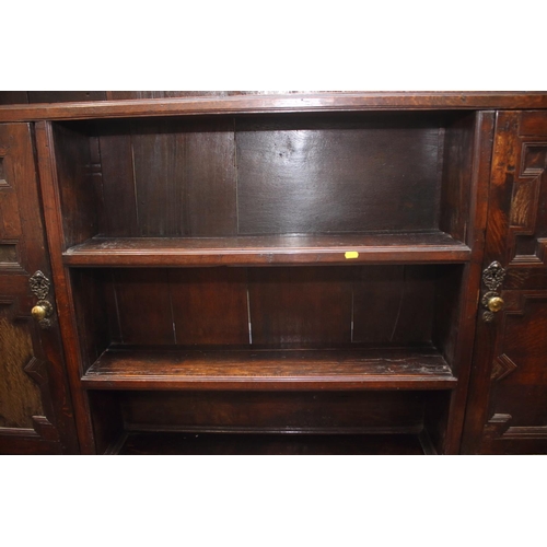 437 - A 19th century oak dresser, the upper section fitted open shelves and cupboards enclosed panelled do... 