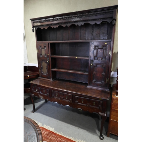 437 - A 19th century oak dresser, the upper section fitted open shelves and cupboards enclosed panelled do... 