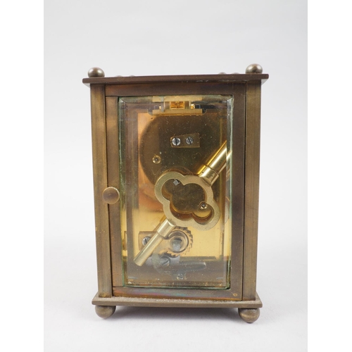 127 - A carriage clock with white enamel dial, supplied by Stuart Dawson & Co Ltd, Hatton Garden, 4