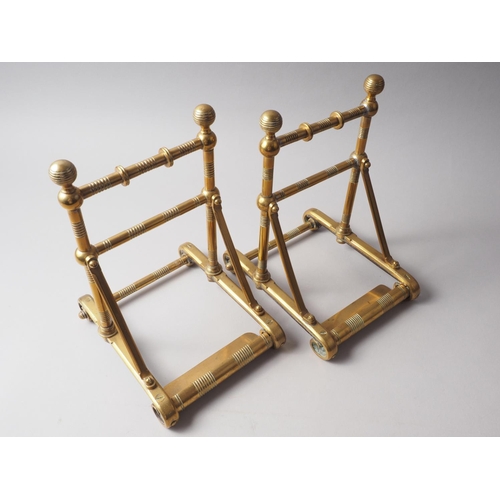 143 - A pair of 19th century Aesthetic Movement turned brass fire implement rests, 11 1/2