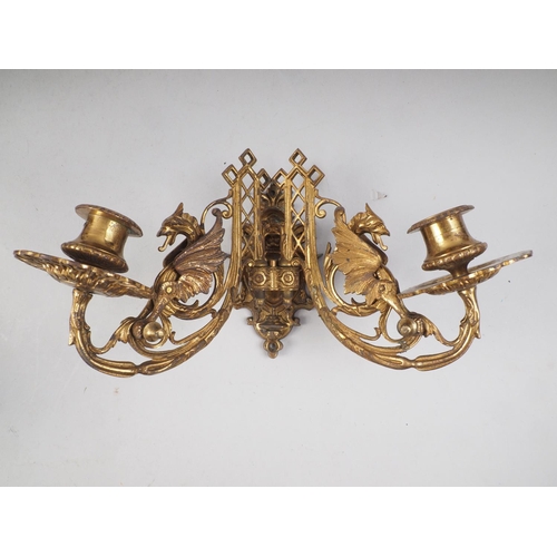 198 - A pair of Art Deco brass two-branch wall sconces with walnut back plates, a pair of two-branch griff... 