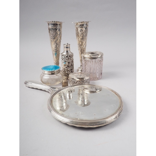 276 - A pair of embossed silver bud vases, on weighted bases, an embossed oval box and cover, a silver mou... 