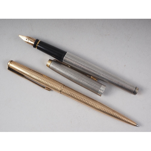 287 - A Parker engine turned silver fountain pen with gold nib, and a similar rolled gold ballpoint pen