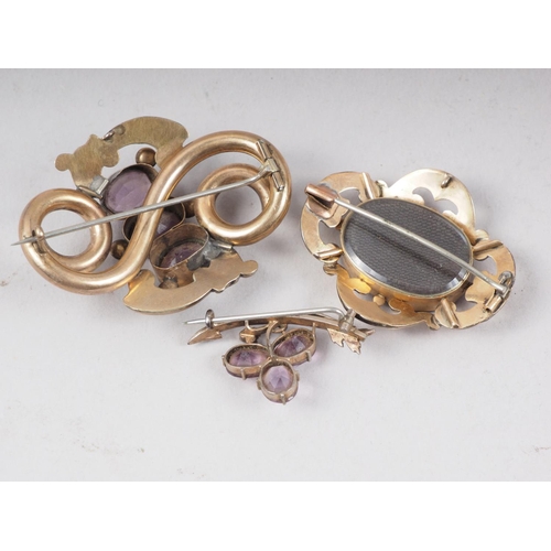 308 - Two 19th century yellow metal and amethyst brooches and a yellow metal mourning brooch, 35.7g overal... 