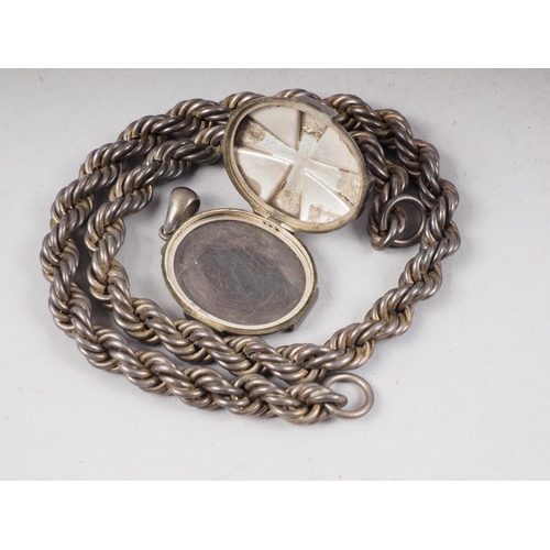 311 - A Victorian white metal locket and a white metal rope twist chain