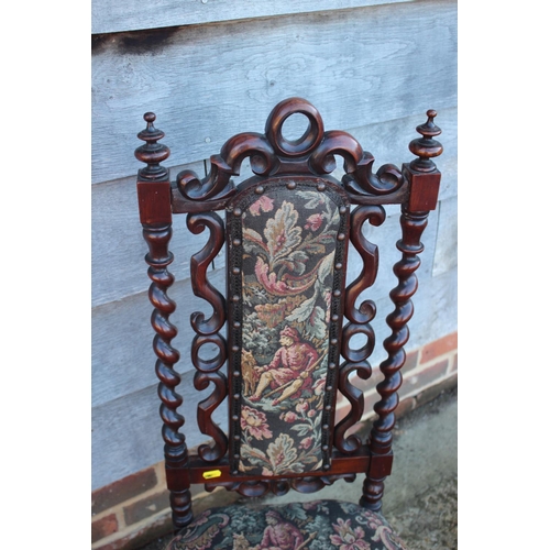 413 - A 19th century carved rosewood framed low seat nursing chair with tapestry panel back and seat, on c... 