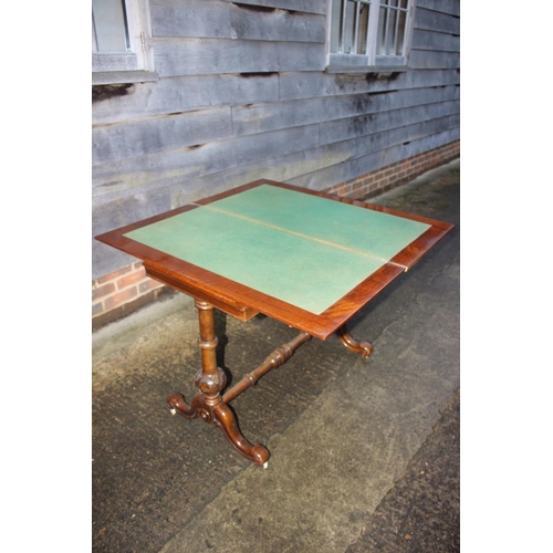 420 - A 19th century figured walnut quartered top fold-over top card table, on turned and carved splay sup... 