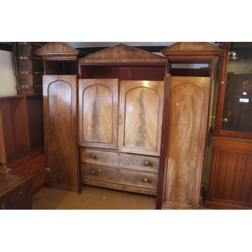 421 - An early 19th century figured mahogany double sentry box wardrobe, the centre section fitted slides ... 