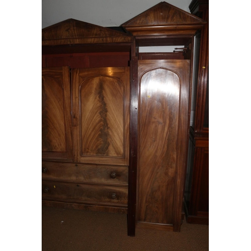 421 - An early 19th century figured mahogany double sentry box wardrobe, the centre section fitted slides ... 