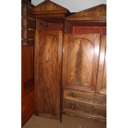 421 - An early 19th century figured mahogany double sentry box wardrobe, the centre section fitted slides ... 