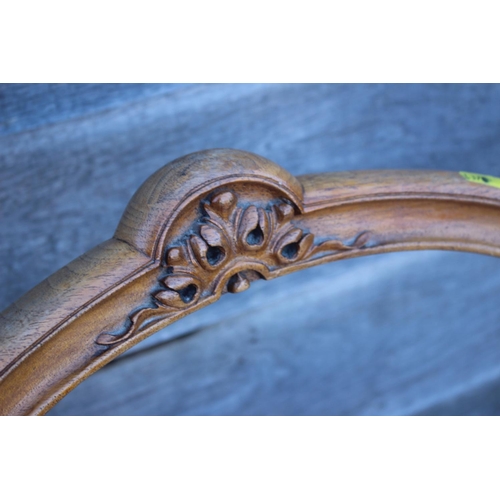 423 - A pair of Victorian carved walnut loop back side chairs, on cabriole supports