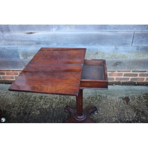 431 - A 19th century figured walnut flap top work table, on octagonal tapered column and quadruple support... 