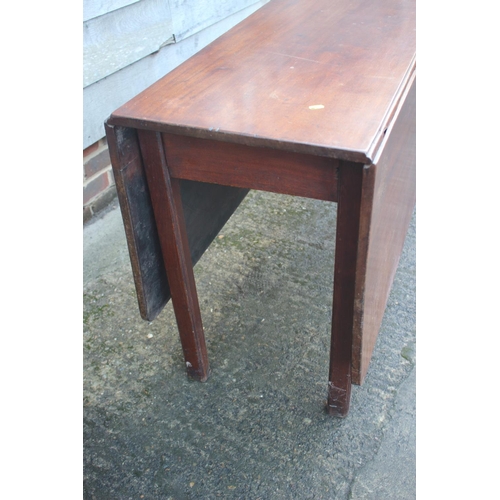 433 - A late Georgian mahogany drop leaf dining table, on moulded and chamfered supports, 48