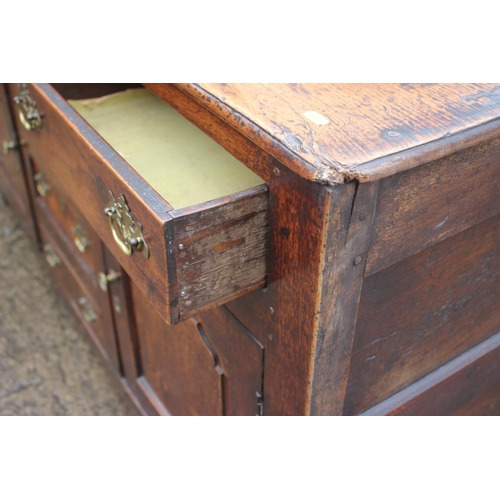 439 - A Georgian oak dresser base, fitted three drawers over three small drawers with flanking cupboards e... 